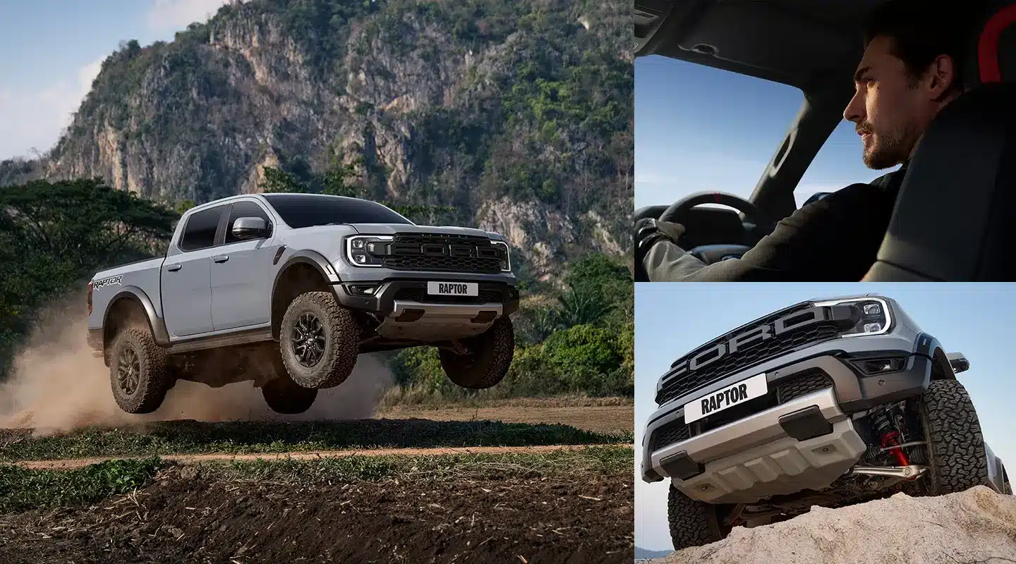 Alt Text: Xe bán tải Ford Ranger Raptor màu xám đang bay trên địa hình off-road đồi núi cát bụi.
